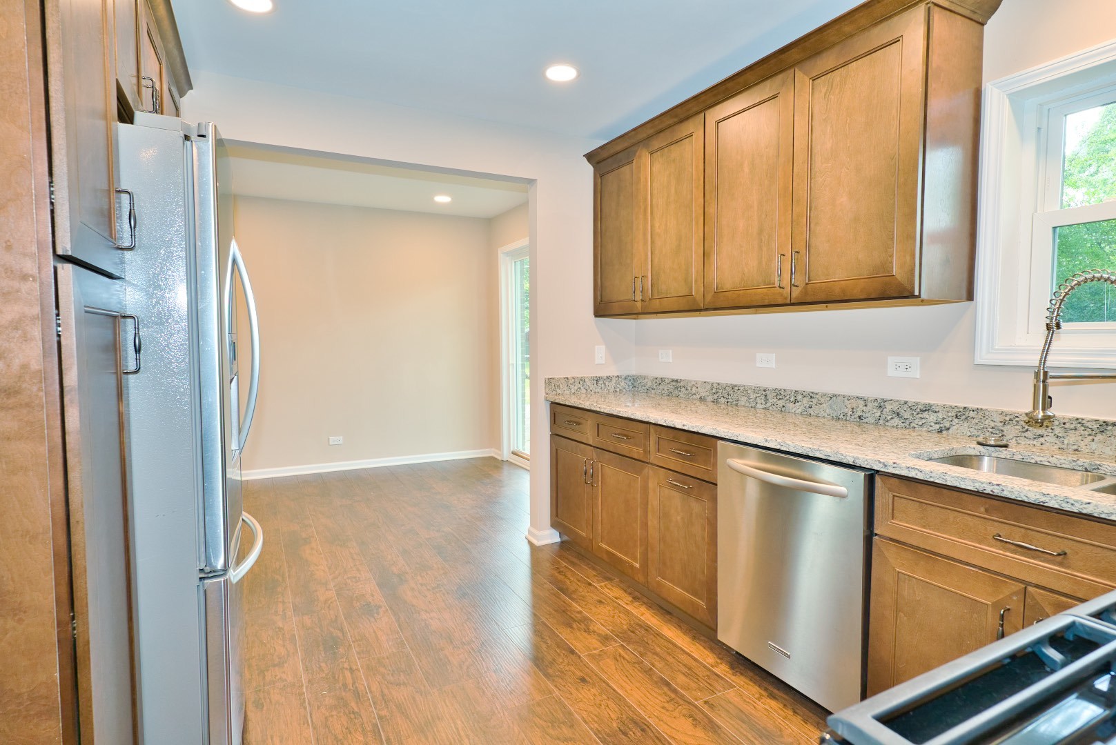 378 Glendale Road Buffalo Grove, IL 60089 - Photo 5 of 23 a kitchen with stainless steel appliances granite countertop a sink and a refrigerator