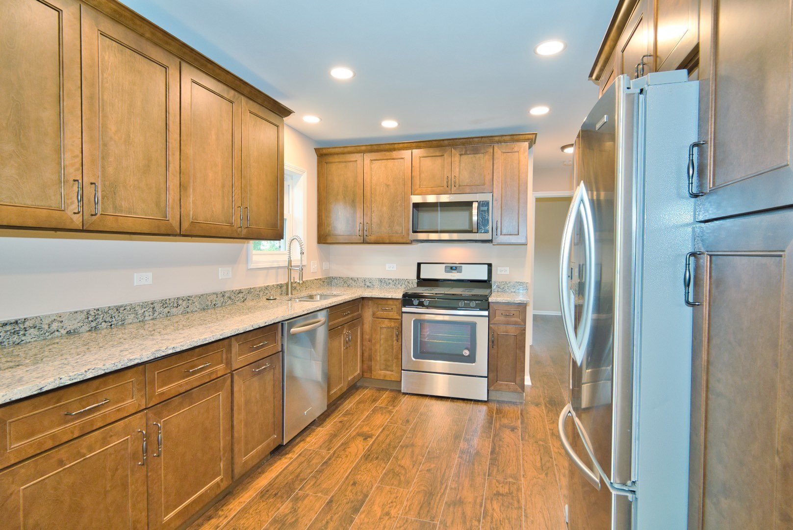 378 Glendale Road Buffalo Grove, IL 60089 - Photo 6 of 23 a kitchen with stainless steel appliances granite countertop a refrigerator and a sink