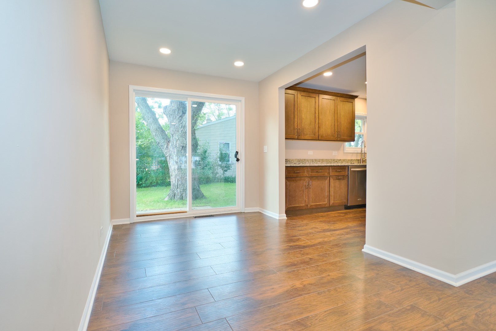 378 Glendale Road Buffalo Grove, IL 60089 - Photo 7 of 23 a view of an empty room with wooden floor and a window