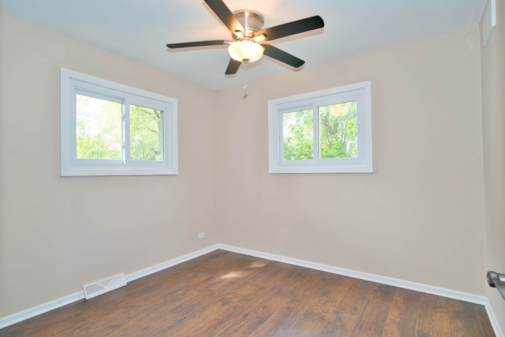 378 Glendale Road Buffalo Grove, IL 60089 - Photo 8 of 23 a view of an empty room with wooden floor and a window