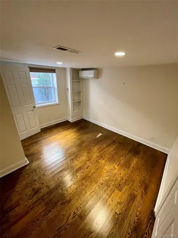 a view of a workspace with wooden floor