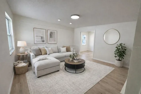 a living room with furniture and a potted plant