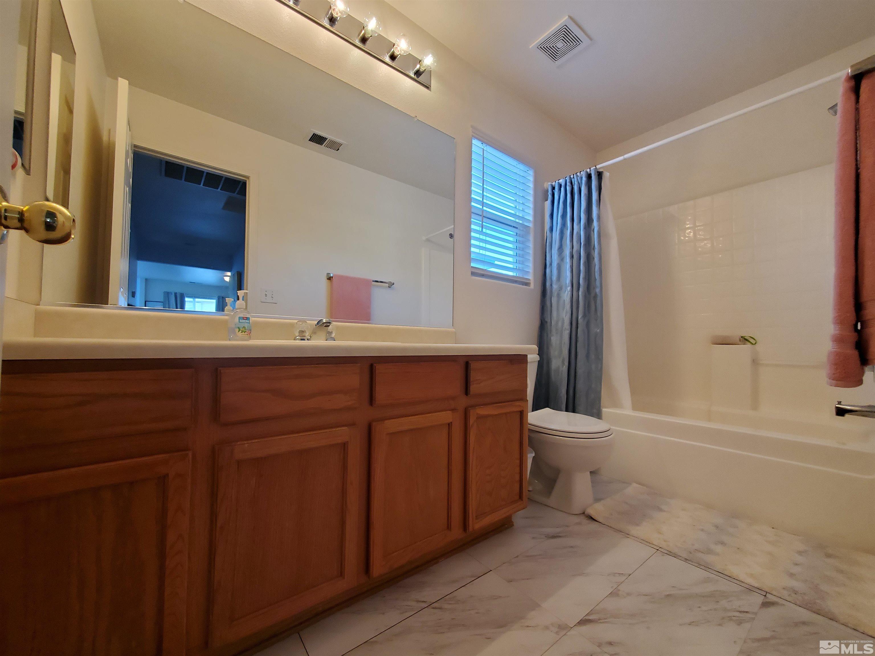 2275 Big Trail Circle Reno, NV 89521 - Photo 18 of 40 a bathroom with a sink a toilet and mirror