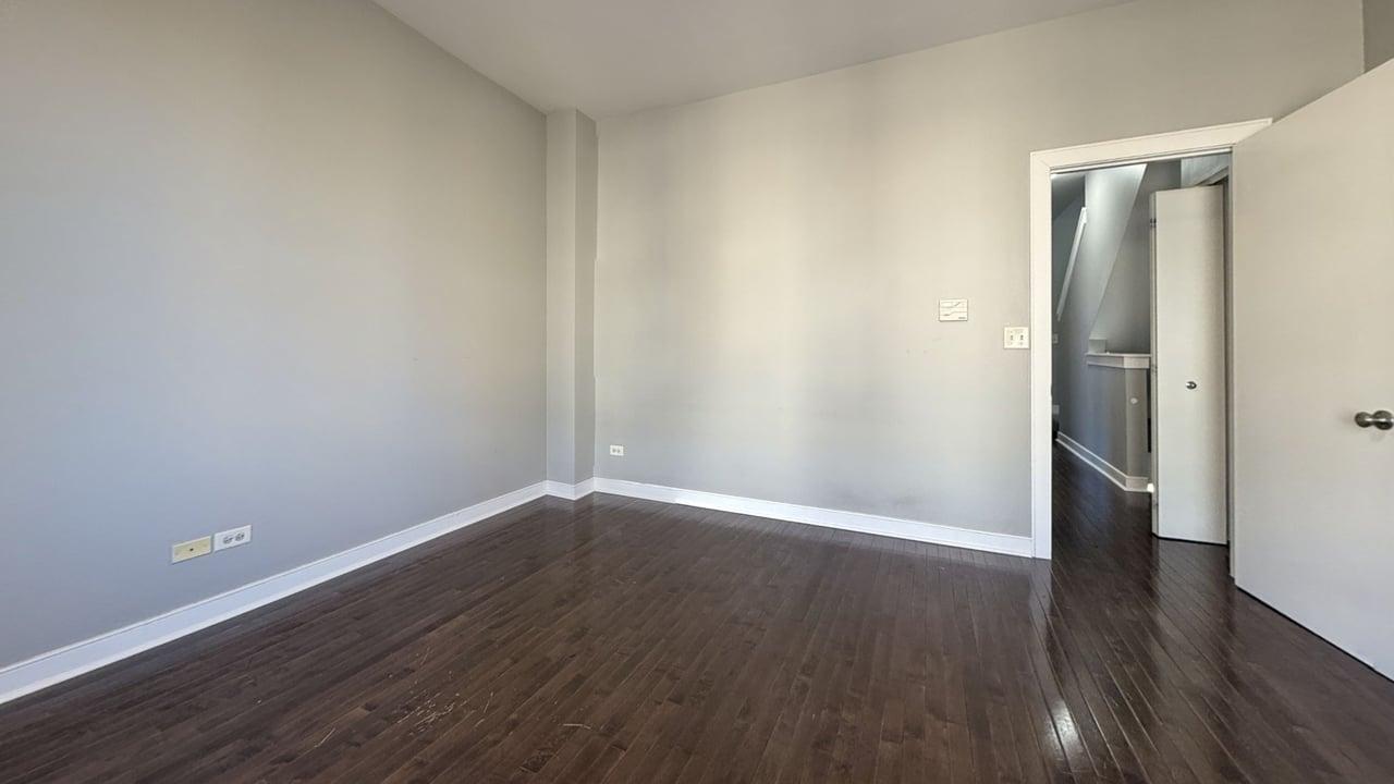 2350 West George Street, Unit 2350 Chicago, IL 60618 - Photo 11 of 21 a view of an empty room with wooden floor