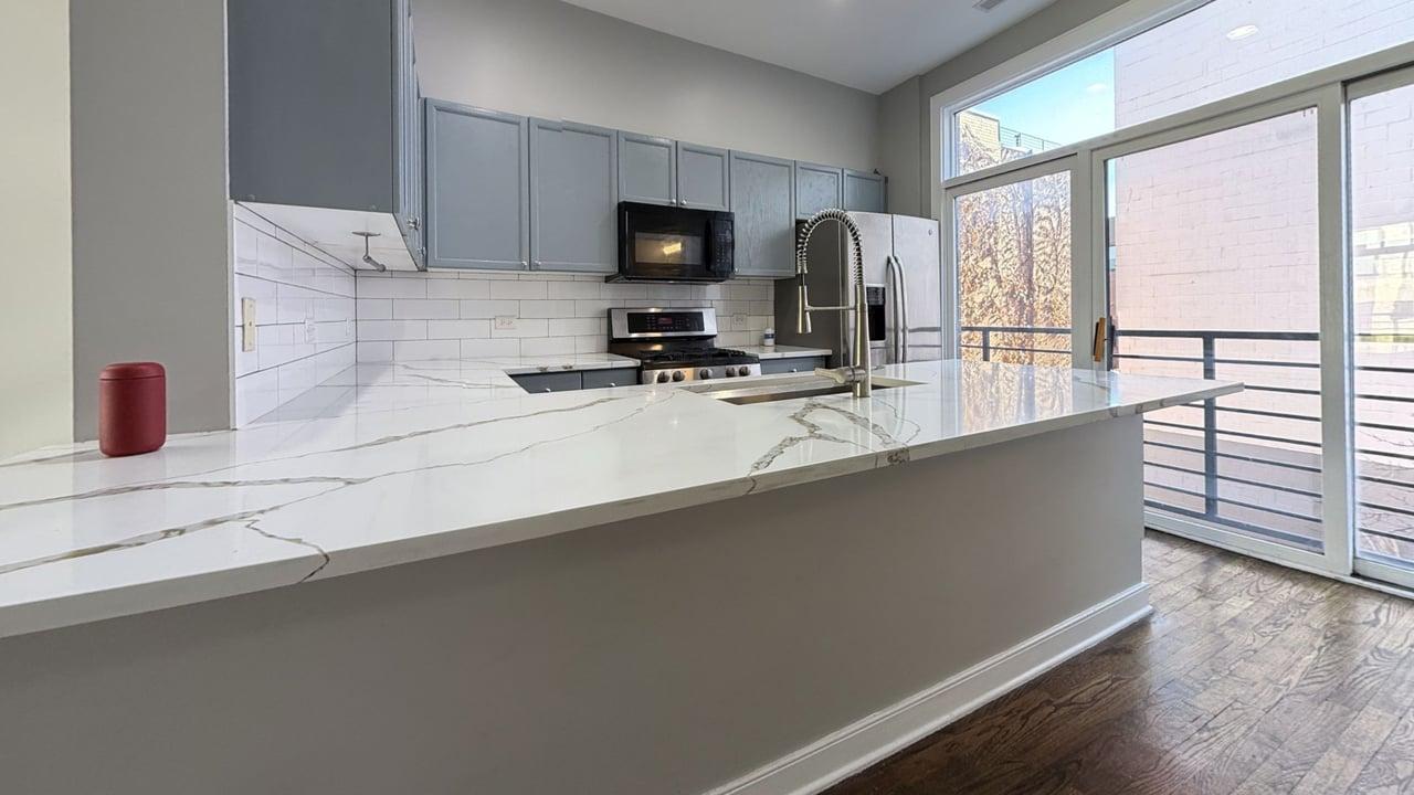 2350 West George Street, Unit 2350 Chicago, IL 60618 - Photo 7 of 21 a kitchen with stainless steel appliances a sink stove and microwave