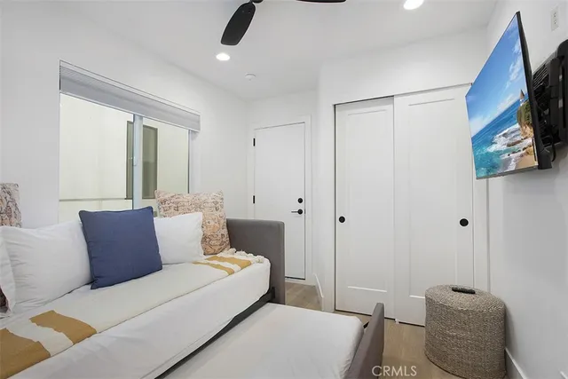 a bedroom with furniture and a flat screen tv