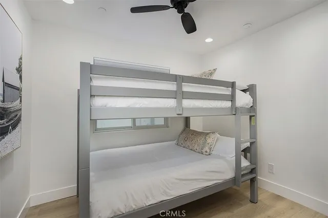 a bedroom with a bed and a ceiling fan