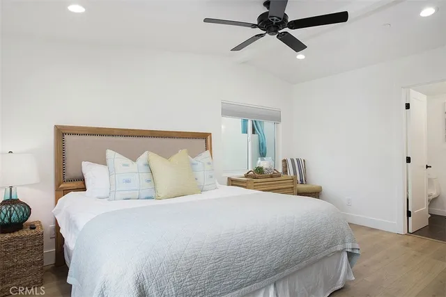 a bedroom with a bed and ceiling fan