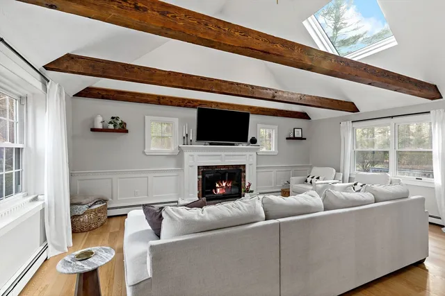 a living room with furniture fireplace and flat screen tv