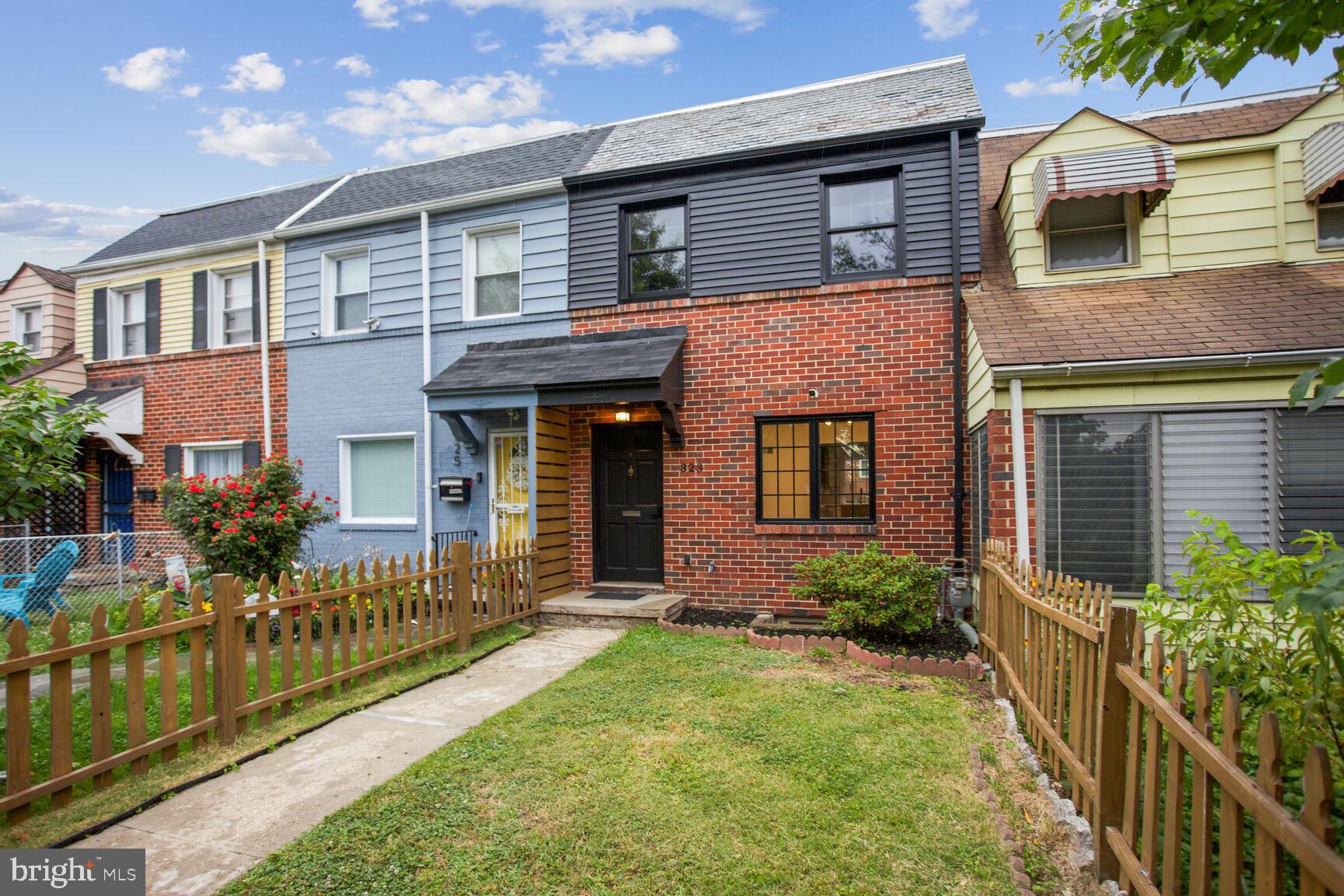 323 34th Street Northeast Washington, DC 20019 - Photo 2 of 28 a front view of a house with a yard