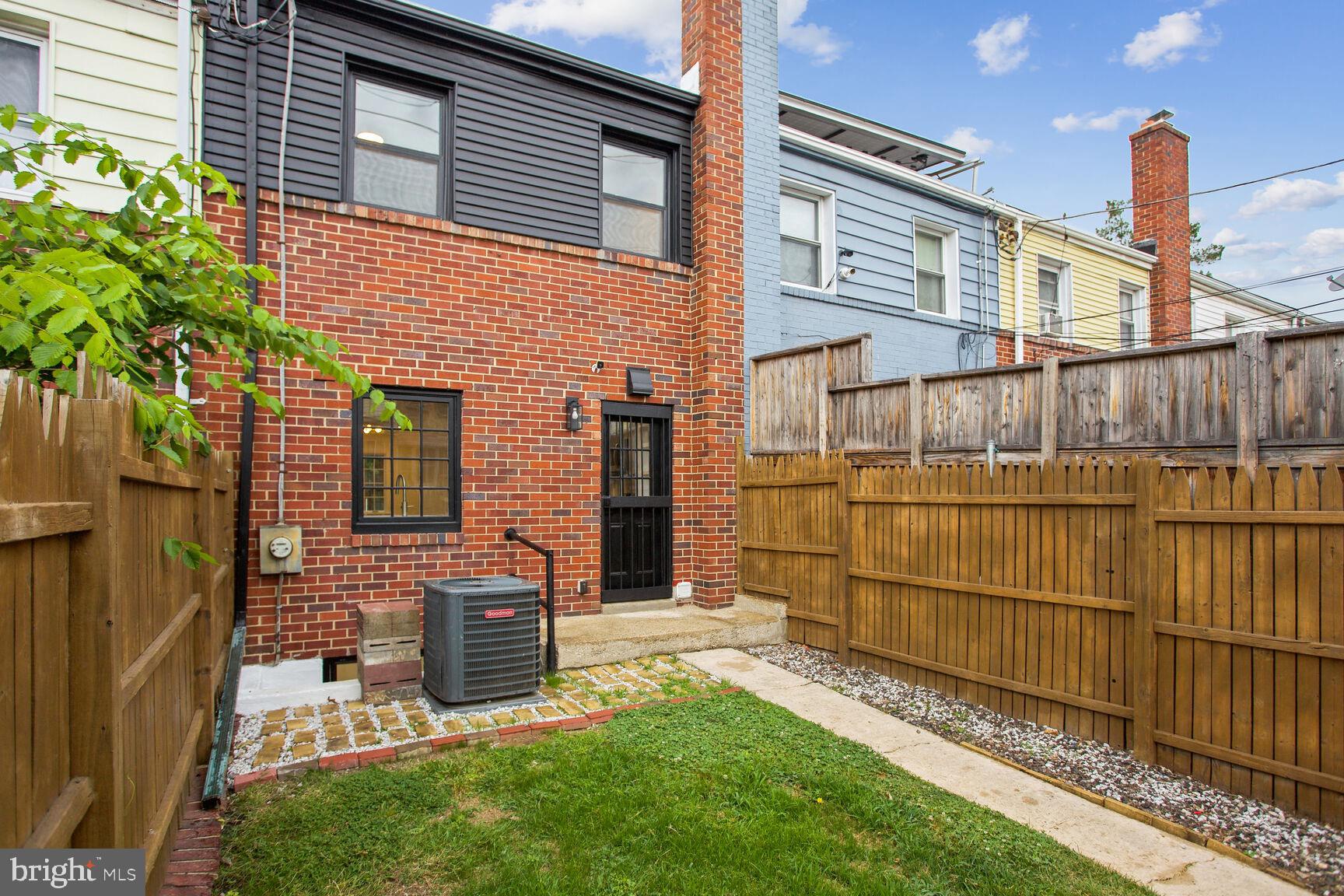 323 34th Street Northeast Washington, DC 20019 - Photo 26 of 28 a view of a brick house with a small yard and wooden fence