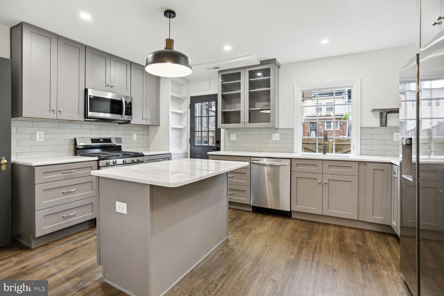 323 34th Street Northeast Washington, DC 20019 - Photo 6 of 28 a kitchen with white cabinets and stainless steel appliances