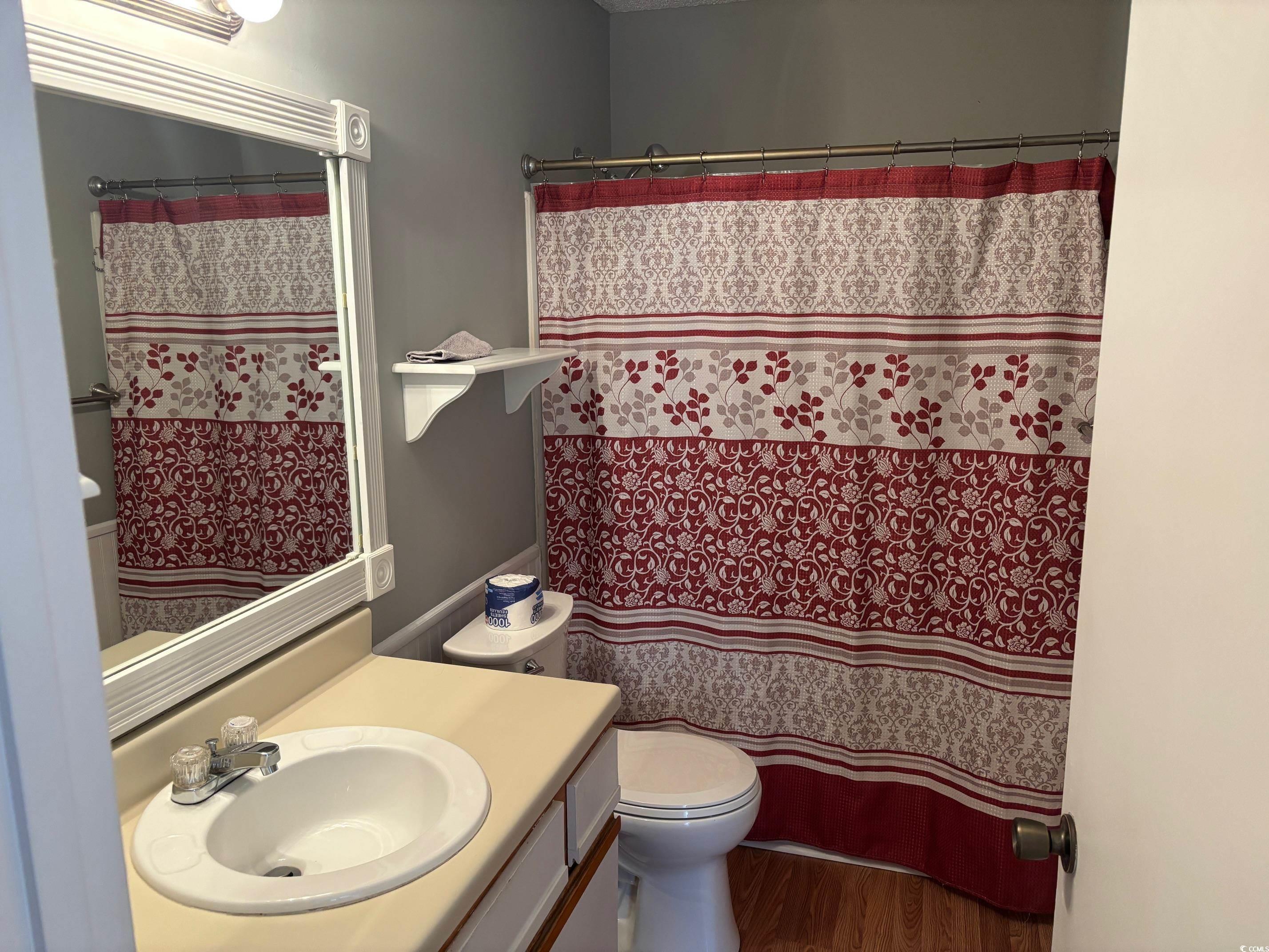 320 A Myrtle Greens Drive, Unit 320A Conway, SC 29526 - Photo 7 of 15 Full bathroom with vanity, curtained shower, and wood finished floors