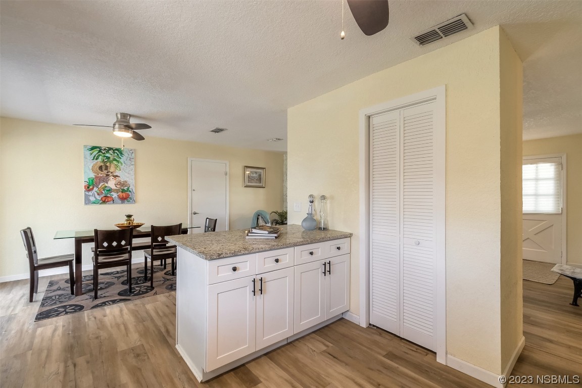 1851 Lime Tree Drive Edgewater, FL 32141 - Photo 12 of 25 a kitchen with a sink cabinets and wooden floor