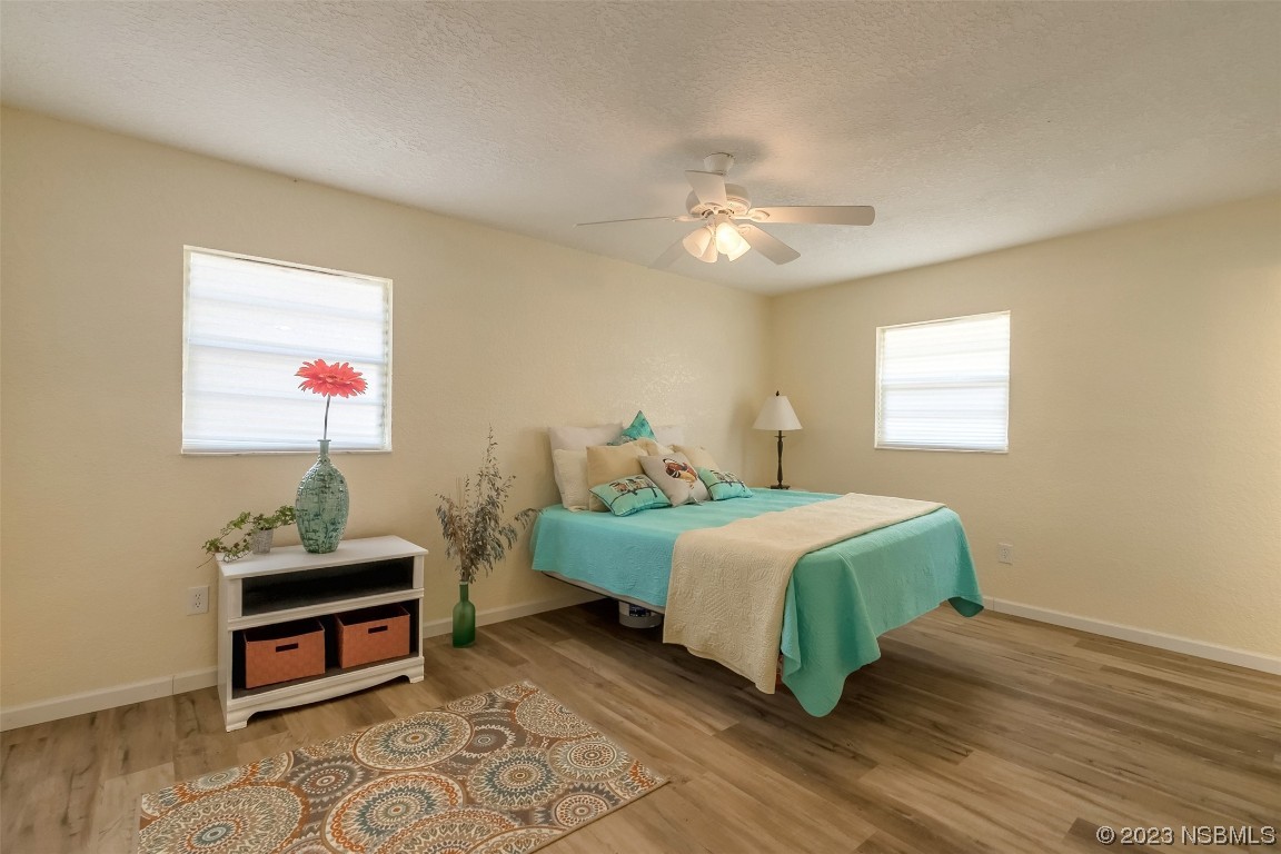 1851 Lime Tree Drive Edgewater, FL 32141 - Photo 13 of 25 a bedroom with a bed and a chandelier