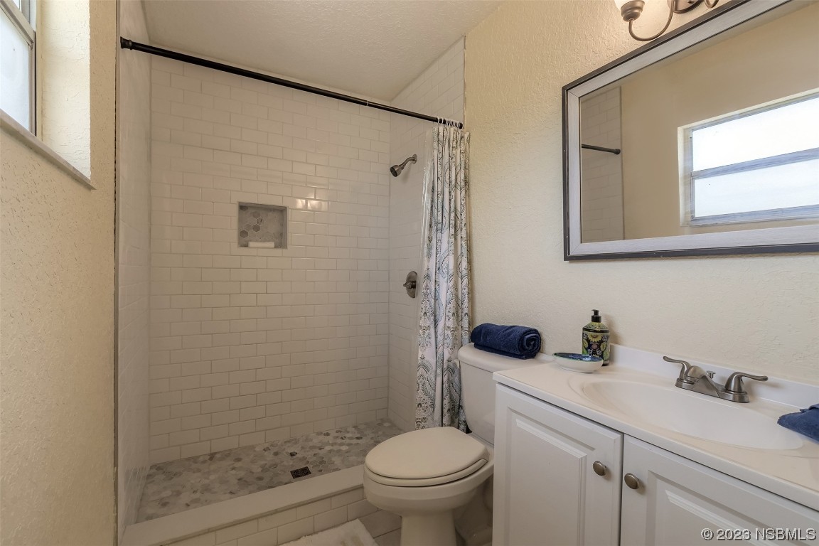 1851 Lime Tree Drive Edgewater, FL 32141 - Photo 15 of 25 a bathroom with a sink a toilet and shower