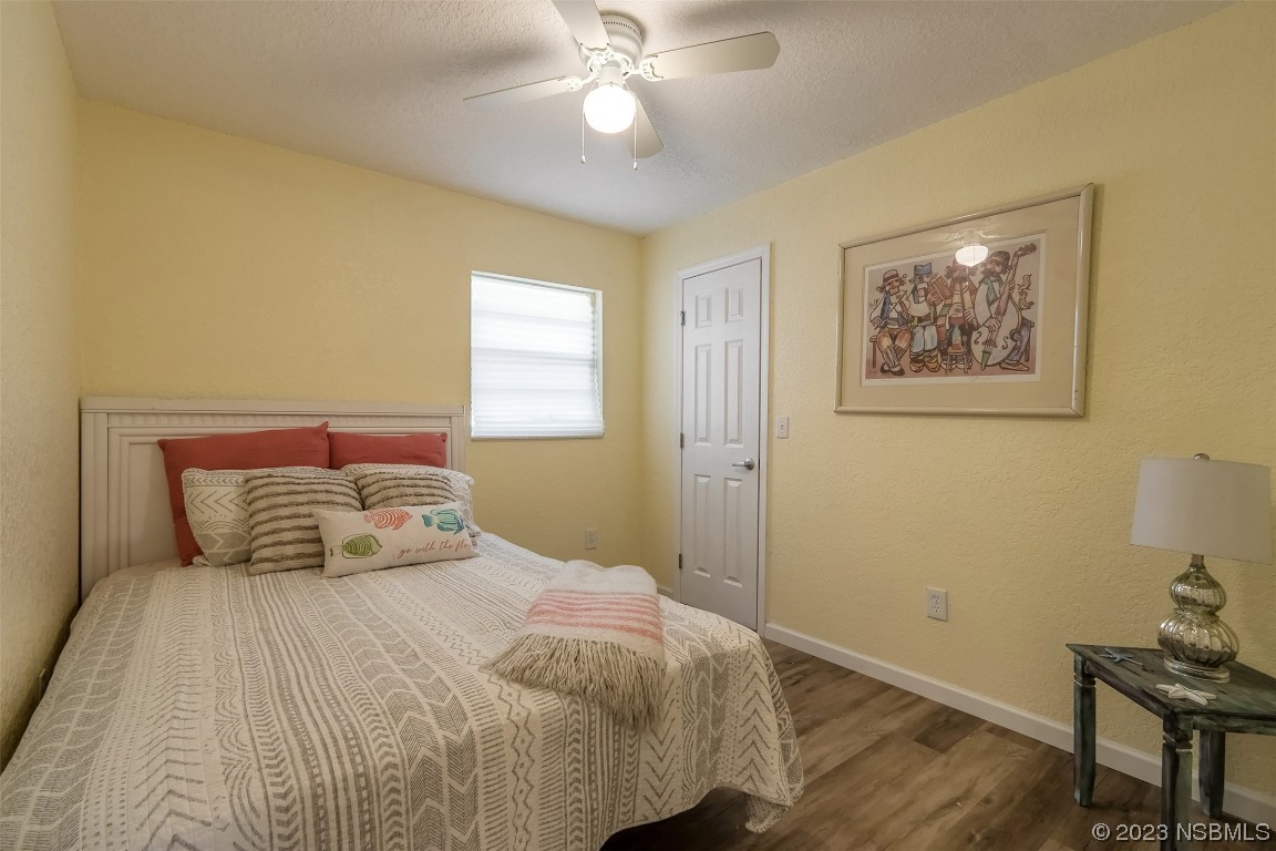 1851 Lime Tree Drive Edgewater, FL 32141 - Photo 16 of 25 a bedroom with a bed and a chandelier