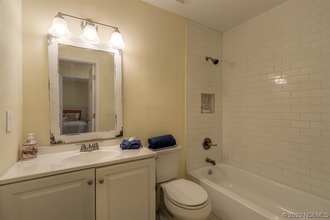 1851 Lime Tree Drive Edgewater, FL 32141 - Photo 17 of 25 a bathroom with a bathtub shower sink vanity mirror and toilet
