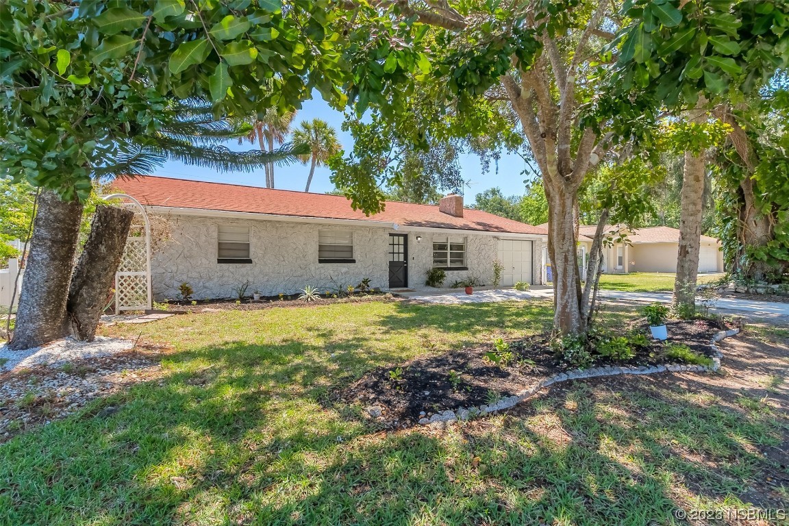 1851 Lime Tree Drive Edgewater, FL 32141 - Photo 2 of 25 a front view of a house with garden