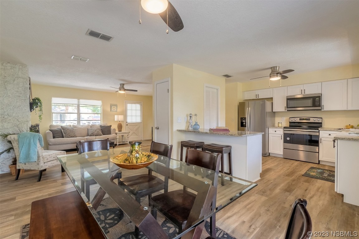 1851 Lime Tree Drive Edgewater, FL 32141 - Photo 8 of 25 a living room with stainless steel appliances furniture and a kitchen view