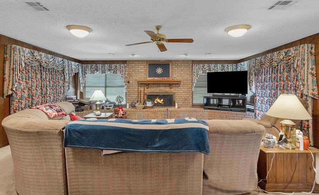 203 River Lane Waco, TX 76708 - Photo 23 of 40 a living room with fireplace furniture and a flat screen tv