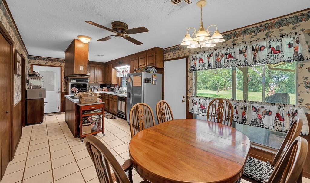 203 River Lane Waco, TX 76708 - Photo 24 of 40 a view of a dining room with furniture wooden floor and chandelier