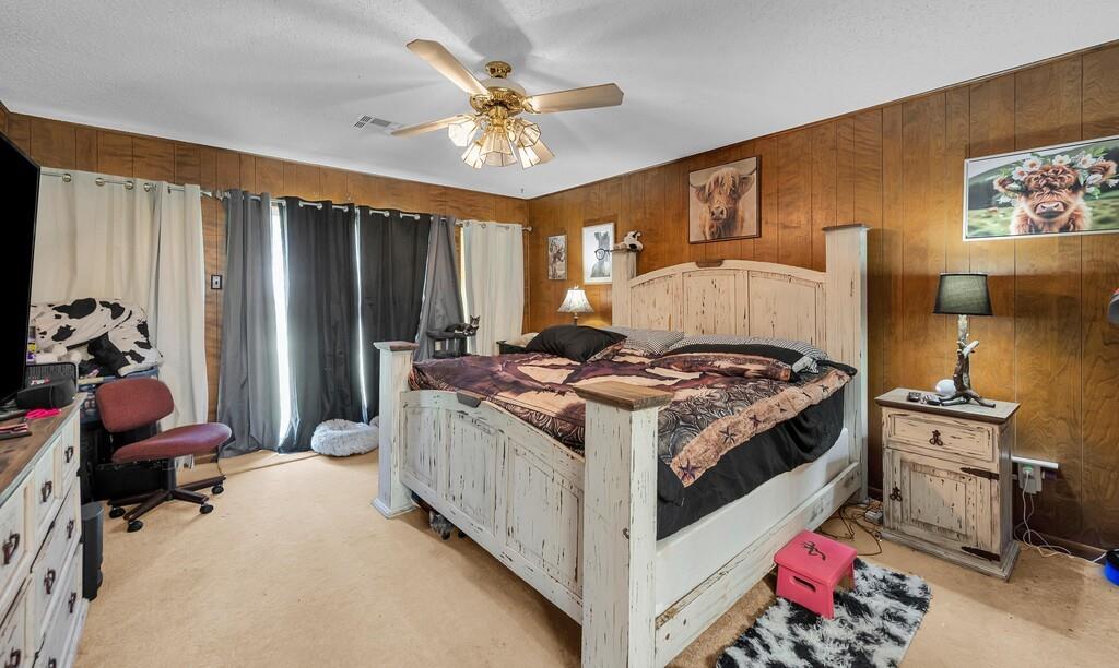 203 River Lane Waco, TX 76708 - Photo 28 of 40 a bed room with a bed and a chandelier