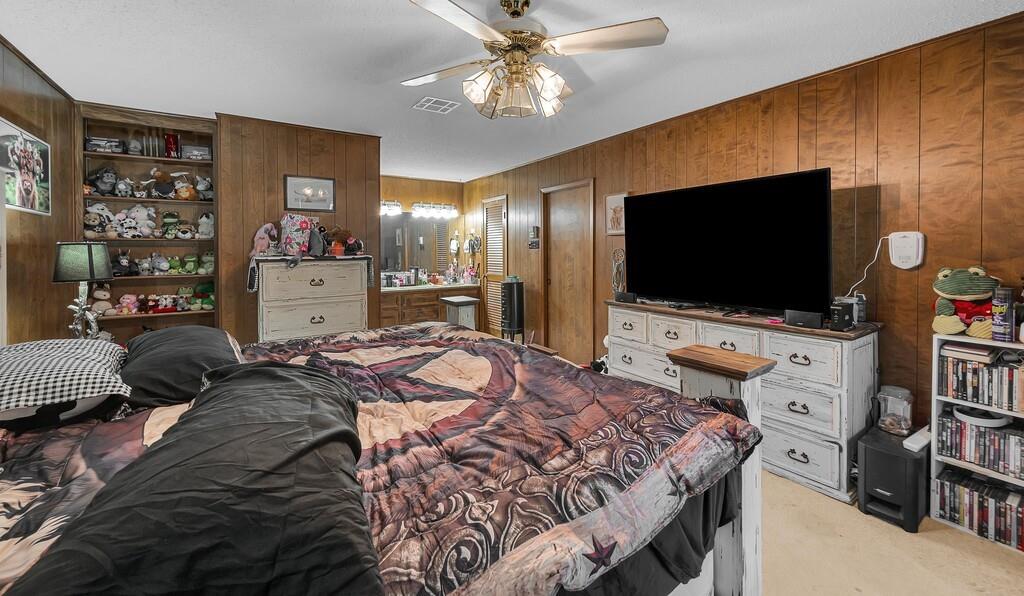 203 River Lane Waco, TX 76708 - Photo 29 of 40 a bedroom with a bed and a flat screen tv