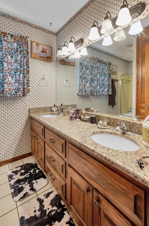 203 River Lane Waco, TX 76708 - Photo 34 of 40 a bathroom with a granite countertop sink and a mirror