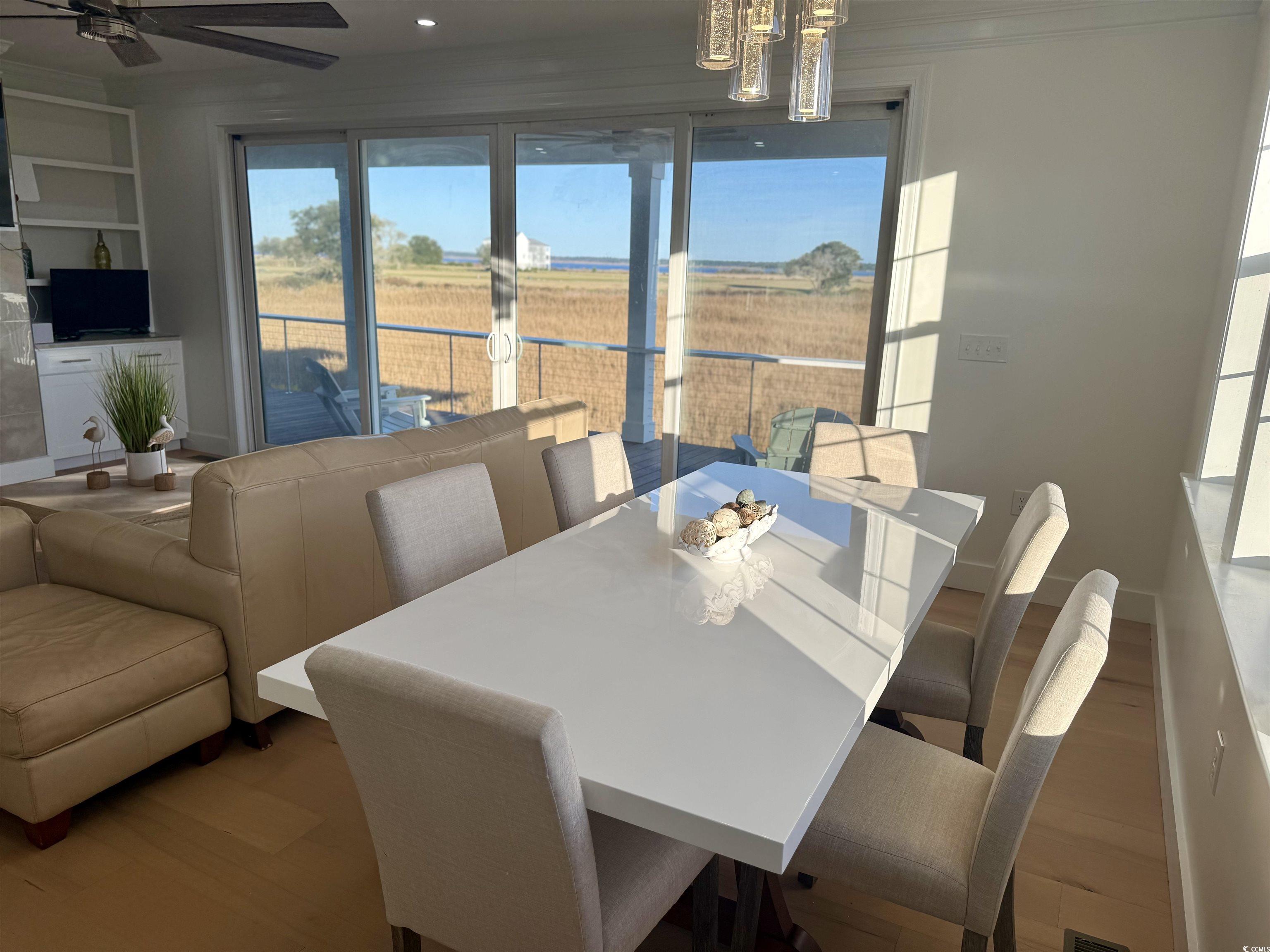 125 Oak Bay Drive Georgetown, SC 29440 - Photo 12 of 39 Dining area featuring wood finished floors and ornamental molding