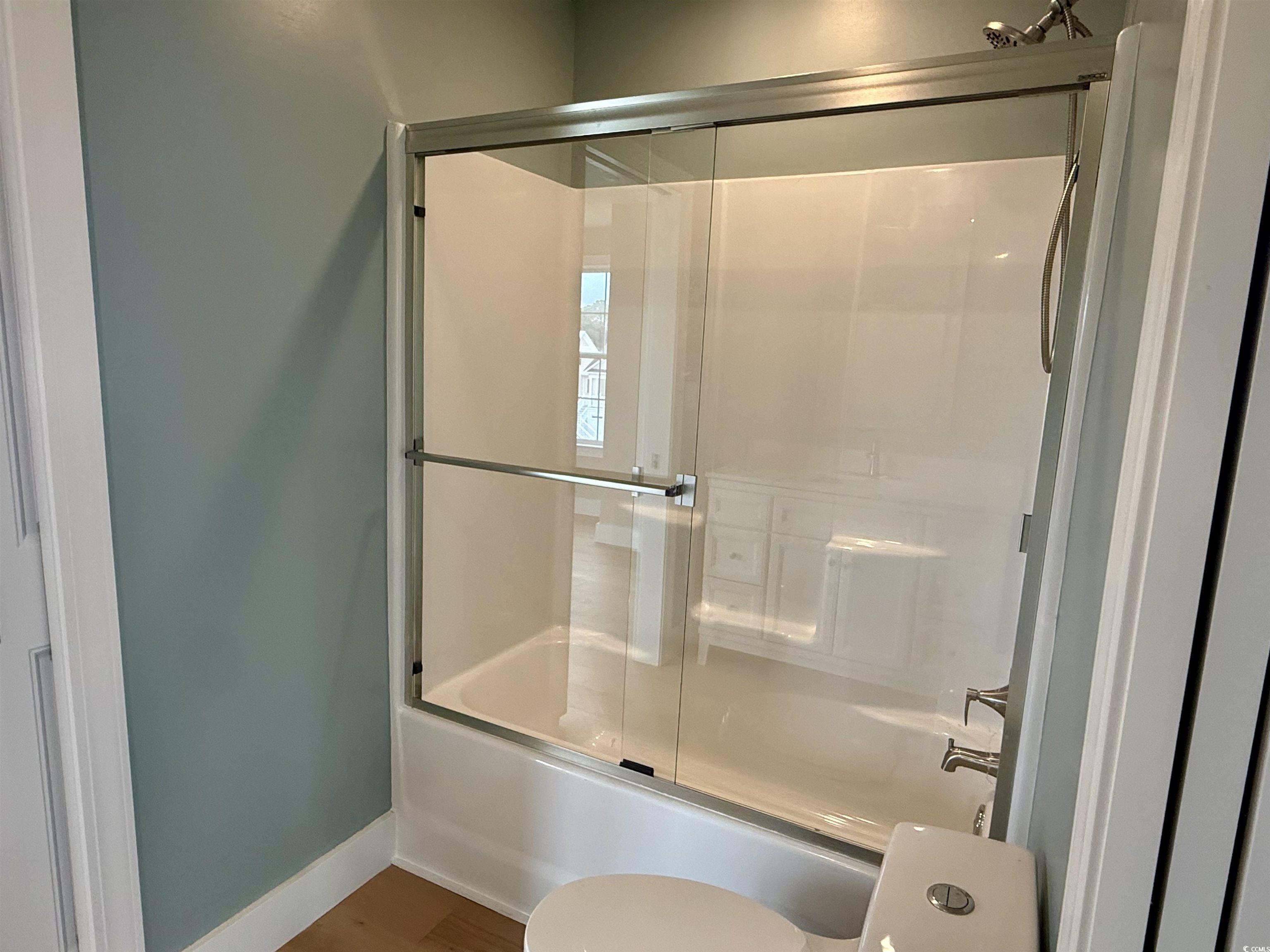 125 Oak Bay Drive Georgetown, SC 29440 - Photo 25 of 39 Full bathroom featuring combined bath / shower with glass door and wood finished floors