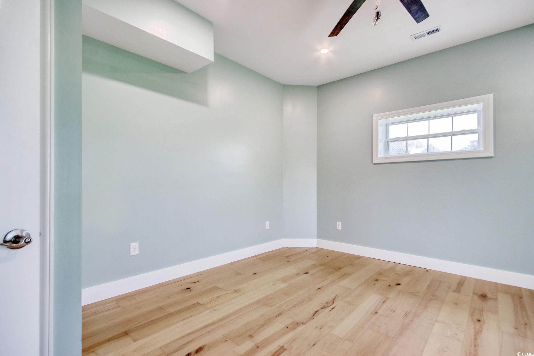 125 Oak Bay Drive Georgetown, SC 29440 - Photo 33 of 39 Empty room featuring a ceiling fan and wood finished floors
