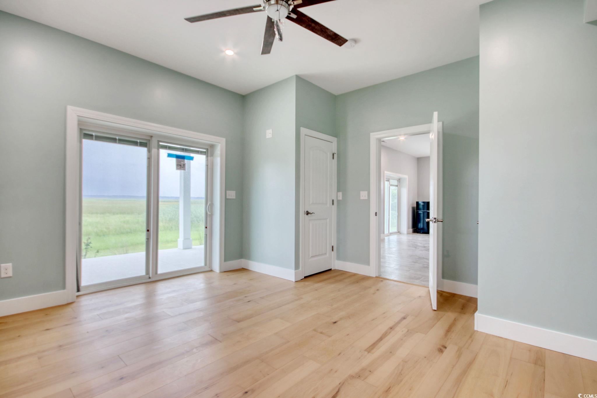 125 Oak Bay Drive Georgetown, SC 29440 - Photo 34 of 39 Spare room featuring ceiling fan, plenty of natural light, and light wood-style floors