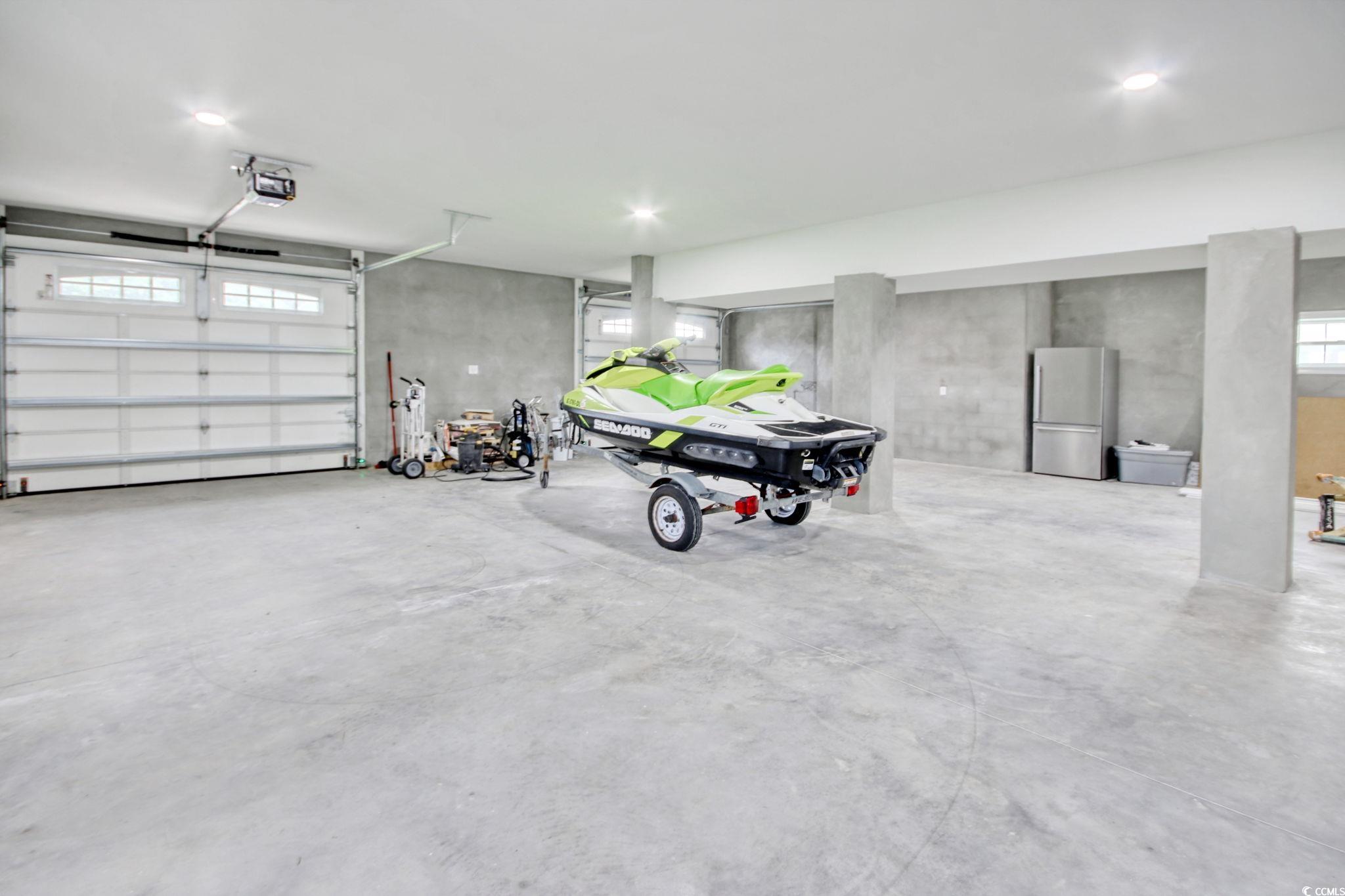 125 Oak Bay Drive Georgetown, SC 29440 - Photo 37 of 39 Garage featuring freestanding refrigerator and a garage door opener