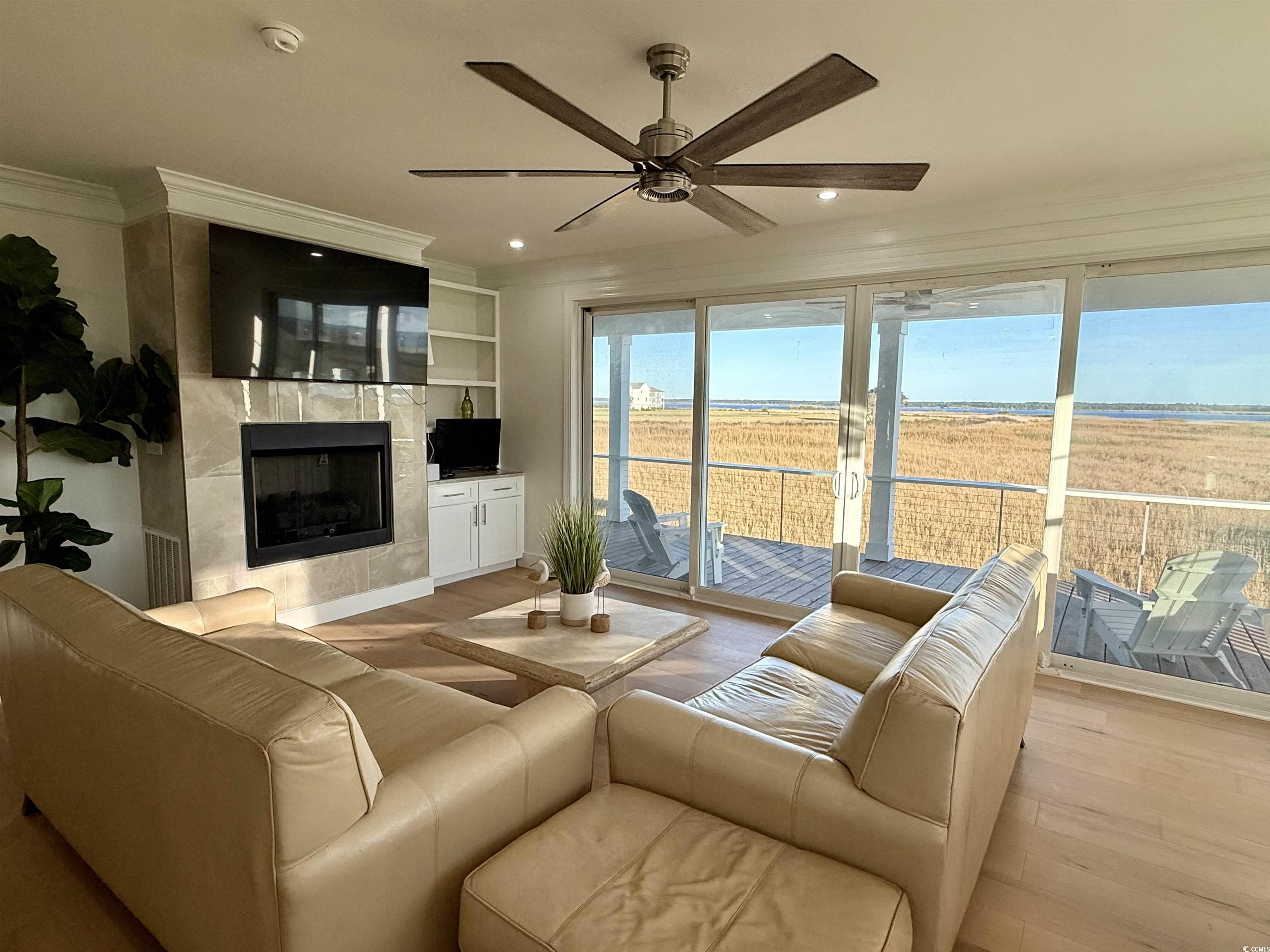 125 Oak Bay Drive Georgetown, SC 29440 - Photo 8 of 39 Living room with wood finished floors, a high end fireplace, ceiling fan, ornamental molding, and recessed lighting