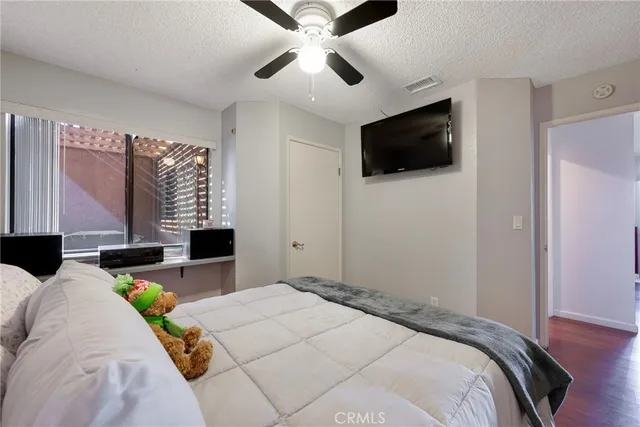 a bedroom with a bed window and couch