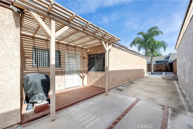 a view of a backyard with fence and a trees