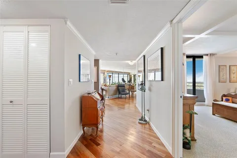 a bedroom with a bed and a large mirror on the dresser
