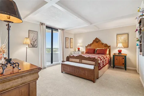 a bedroom with a bed and dresser with mirror