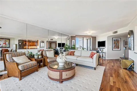 a large kitchen with granite countertop a large counter top appliances and cabinets