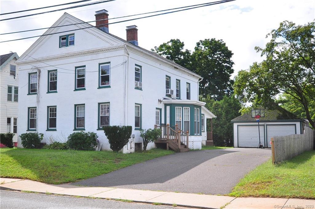 70 Spring Street Windsor Locks, CT 06096 - Photo 1 of 1 a front view of a house with a garden and plants