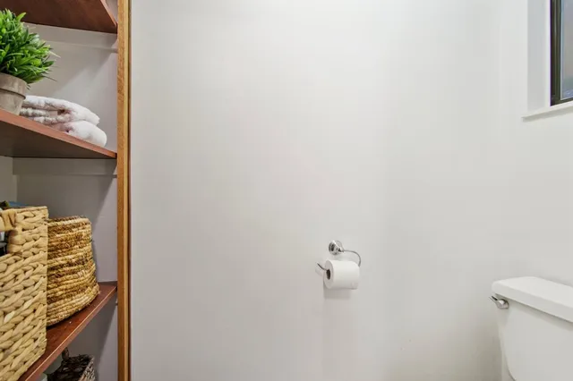 a view of a hallway with wooden cabinets