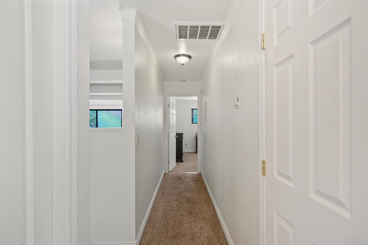 18950 Black Oak Road Sonora, CA 95370 - Photo 17 of 46 a view of a hallway with wooden cabinets