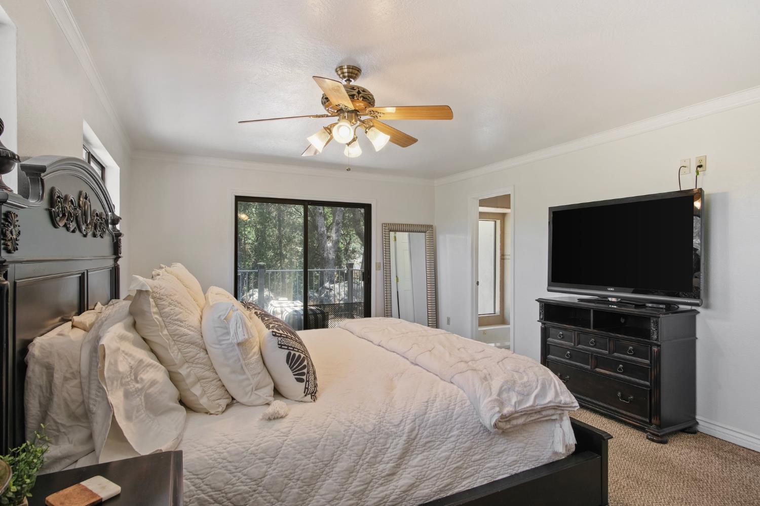 18950 Black Oak Road Sonora, CA 95370 - Photo 19 of 46 a bedroom with a bed and a flat screen tv