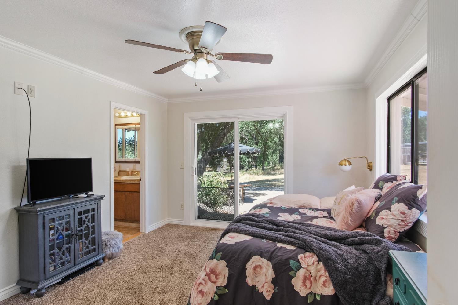 18950 Black Oak Road Sonora, CA 95370 - Photo 27 of 46 a bedroom with a bed and a flat screen tv