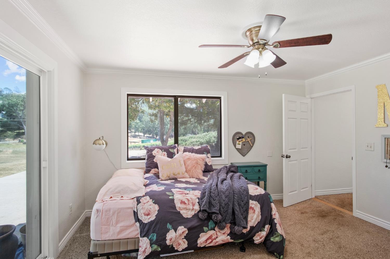 18950 Black Oak Road Sonora, CA 95370 - Photo 28 of 46 a bed room with a bed and a chandelier