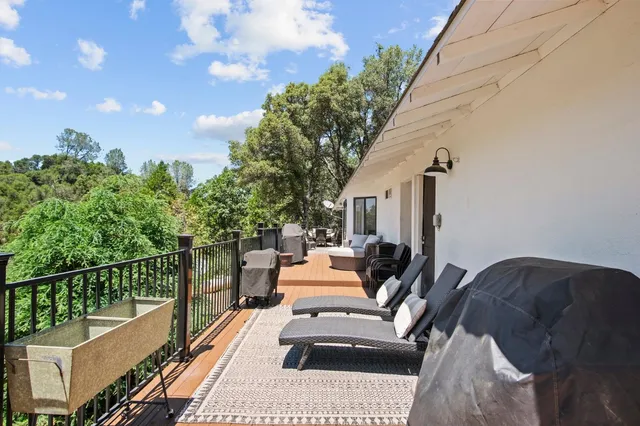 a view of a patio with couches table and chairs and potted plants