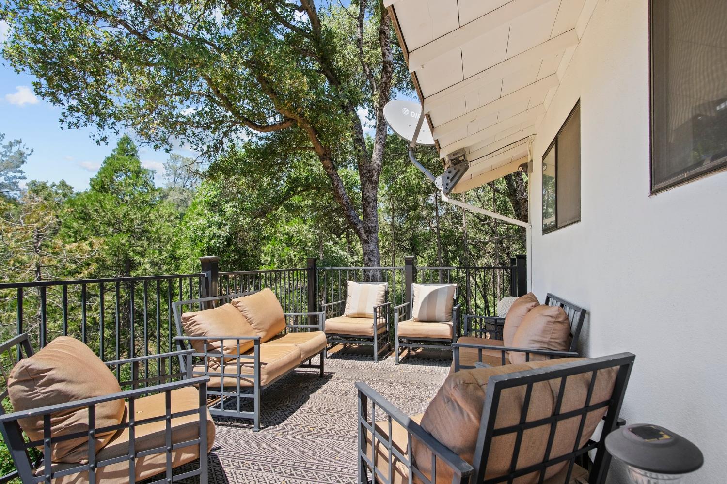 18950 Black Oak Road Sonora, CA 95370 - Photo 35 of 46 a balcony with couple of chairs and a potted plant