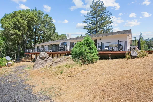 an aerial view of a residential houses with yard