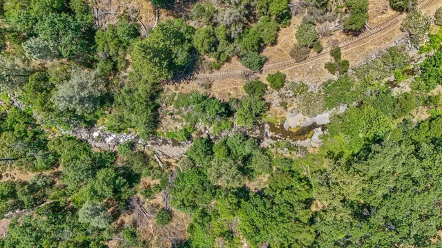an aerial view of residential house and car parked